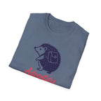 Folded blue t-shirt with a hedgehog and 'Adventure' text on a white background